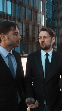 4k. UHD. Three young attractive succesful businesspeople ask You to answer call from Your Boss POV. Super wide shot. Sunny morning. Businessmen and businesswoman outdoor in modern fachion building