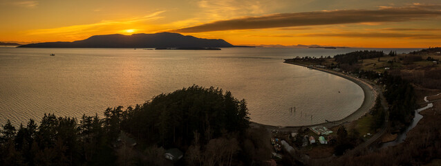 Aerial panoramic sunset view of Legoe Bay and the west side of Lummi island, Washington. Orcas...
