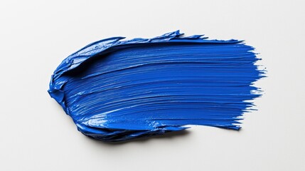 Fototapeta premium A vibrant blue paint smear on a white background, showcasing texture and color.