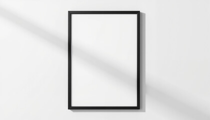 Empty black picture frame against white wall