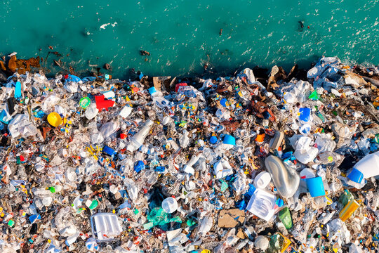 plastic waste in a landfill next to the ocean, top view. environmental pollution