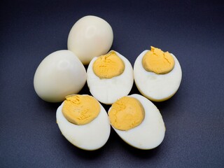 Boiled egg slices isolated on a black background