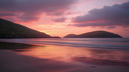 Obraz premium Serene sunset over a secluded beach, reflecting the vibrant pink and orange hues of the sky. Calm waves lap gently on the shore, creating a peaceful atmosphere.