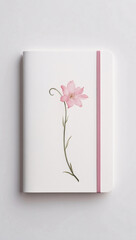 White sleek notebook with soft pink flower and leaf watercolor illustration on the cover ideal for a serene aesthetic