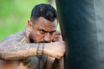 Portrait of sexy boxer. Man boxer face close up. Fists fight. Mans fight, punches. Kicks up. In the...