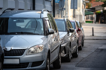 A row of cars parked along a Belgrade street in Serbia, illustrating daily urban transport needs. Tight spacing highlights the city&rsquo;s limited parking solutions and local routines.