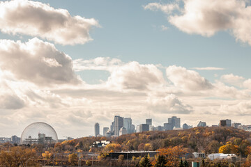 Seen from Jean Drapeau Park in autumn, the skyline blends the Biosphere, modern towers, and...