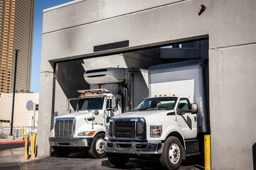 LAS VEGAS - AUGUST 23, 2024: Delivery trucks at a Las Vegas warehouse loading zone managing freight & unloading tasks in this commercial facility, reflecting active shipping and trucking operations.