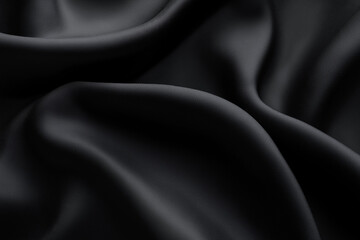 Fototapeta premium A simple and elegant black fabric background with soft folds and texture, creating a luxurious and minimalistic atmosphere.
