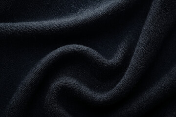 Fototapeta premium A simple and elegant black fabric background with soft folds and texture, creating a luxurious and minimalistic atmosphere.