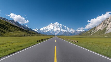 Fototapeta premium Majestic Highway Leading to Snow-Capped Mountains under Clear Blue Sky with Lush Green Fields on Both Sides in a Scenic Landscape