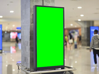 vertical LCD screen with blank green screen at airport. Chroma key screen concept for video.