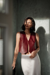 Fototapeta premium Indoor portrait of young sensual sexy posing near the window. Portrait of beautiful fashion stylish brunette woman model with natural makeup.