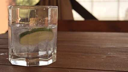 Refreshing lime cocktail with soda served in glass filled with sparkling bubbles Close-up of lime slices adding vibrant green color and fresh citrus aroma Lime drink perfect for summer vibes