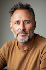Obraz premium Portrait of confident mature man with graying hair and beard wearing casual clothing