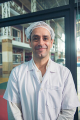 Vertical Caucasian Scientist test experiment research data science laboratory. Expert man use microscope laptop medical analyze. Portrait Biochemistry scientist white lab coat mask face shield