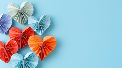 Obraz premium Valentine Cards concept. Colorful paper hearts arranged on a blue background, creating a cheerful and artistic display perfect for Valentine's Day or creative projects.