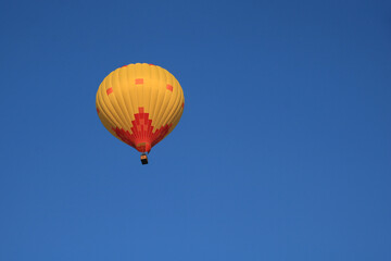 Yellow orange hot air balloon over Vang Vieng, Laos.