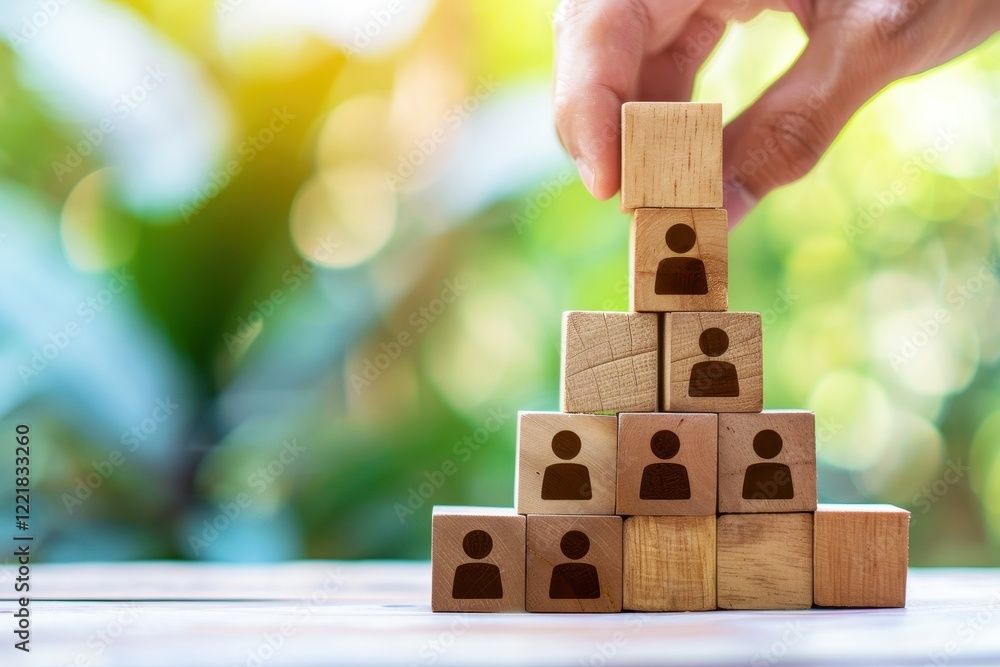 Poster stacking wooden blocks with human icons against a nature background to represent team building and c