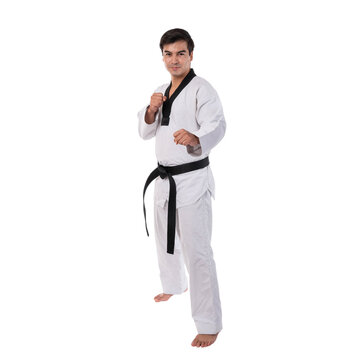 Male Taekwondo athlete in a traditional white dobok with a black belt, demonstrating a fighting stance against isolated on a transparent background