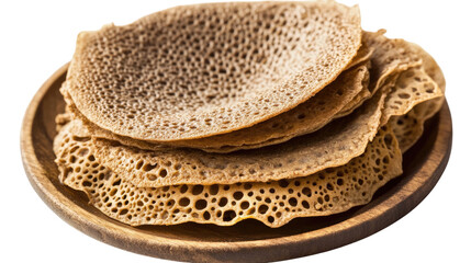 Injera Flatbread: A stack of freshly baked injera flatbread, a staple food in Ethiopian and Eritrean cuisine, sits on a wooden plate. The thin.