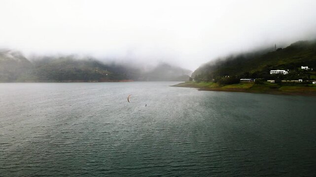 kitesurfing in the fog at lake calima colombia