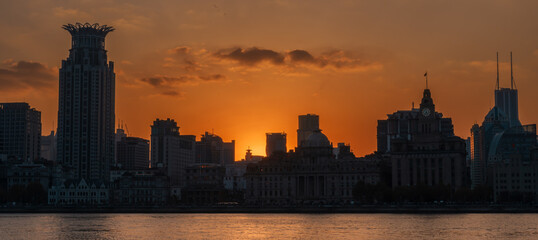 Fototapeta premium Cityscape view of Shanghai city at sunset. Skyscraper of the Bund, view from Lujiazui in Pudong of Shanghai, China. landmark and popular for tourism attractions. Travel and Vacation concept