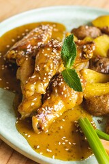 Golden mustard-glazed chicken wings served crispy and flavorful, perfect as a delicious snack or appetizer in a casual dining setting.