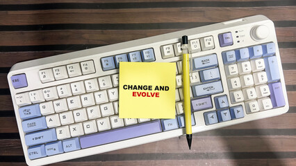 Concept of Change and Evolve write on sticky notes isolated on Wooden Table.