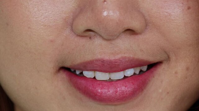Healthy asian woman with beautiful smile, pink red lips smiling gently, charming and beautiful face happy : Video was shot in a room.