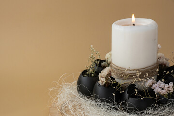 Creative handmade Easter table decoration with egg shells instruction candle on pastel beige...