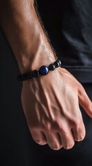 Elegant black onyx and blue sapphire bracelet on man's hand with semi-robotic elements