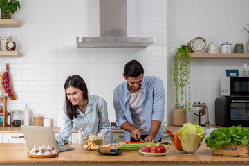 Multiracial couple online shopping. Reading some reviews on restaurants to check out.