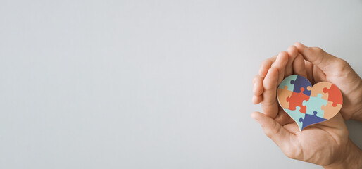 hands holding jigsaw puzzle heart shape, Autism awareness,Autism spectrum disorder family support concept, World Autism Awareness Day 