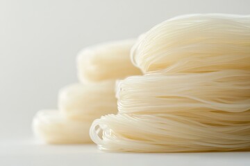 Neatly Arranged Japchae Noodles on Plain Background