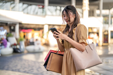 Asian woman shopping online using smartphone, e-commerce, digital cart, payment process, delivery...
