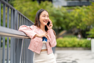 Portrait of smiling happy beauty asian business woman relaxing using digital technology...