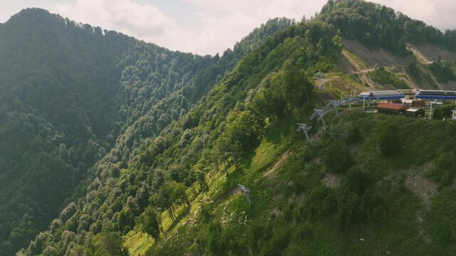 Drone view of lush mountains with forest landscape and unpaved roads on hill in Gebele, Azerbaijan