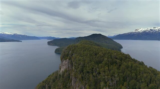 Upward revealing drone shot over island in Parque Nacional Arrayanes in south argentina. Conservation forest makes main scene subject. Shot 4K-60fps.