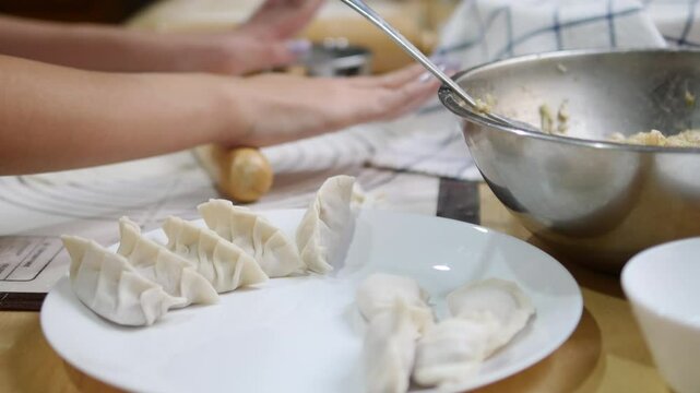 Hands rolling out gyoza dough on a floured surface with precision, showcasing the process of crafting Japanese dumpling wrappers, with kitchen tools like a rolling pin and sifter in the background