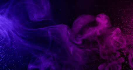 Multicolor ink. Smoke spray. Violet purple puff streams spreading in dark water. Neon defocused abstract night texture background.