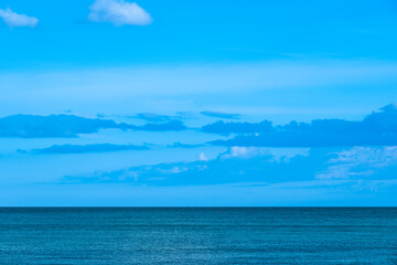 Nature of the beach and sea Summer with sunshine, sandy beaches, clear blue waters sparkling against the blue sky. On an island with good ecology and environment Background for summer vacation