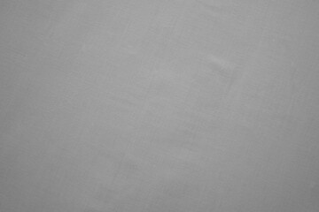 Close-up of texture of plain grey fabric. Monochromatic textile material background for design and templates. Copy space.