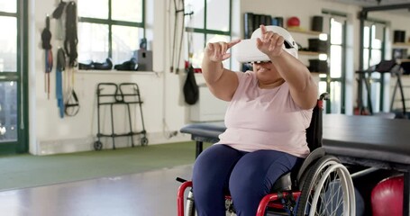 Using VR headset, woman with paraplegia in wheelchair participating in therapy session, copy space