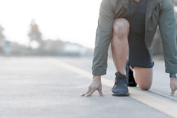 A male athlete enjoys a morning run in the park, smiling and exercising outdoors. Embracing fitness...