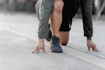 A male athlete enjoys a morning run in the park, smiling and exercising outdoors. Embracing fitness and happiness, he maintains a healthy lifestyle, feeling energized and positive in nature.