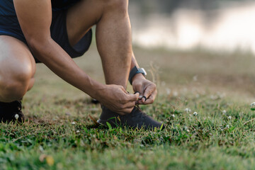 A male athlete enjoys a morning run in the park, smiling and exercising outdoors. Embracing fitness and happiness, he maintains a healthy lifestyle, feeling energized and positive in nature.