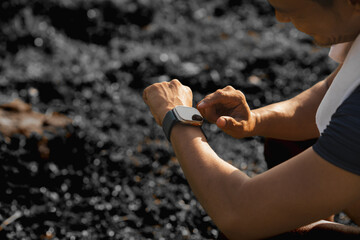 A male athlete enjoys a morning run in the park, smiling and exercising outdoors. Embracing fitness and happiness, he maintains a healthy lifestyle, feeling energized and positive in nature.