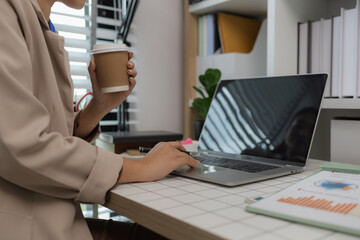 an employee sits working in an office full of documents that need to be completed on time, the marketing team leader is reviewing documents related to marketing information
