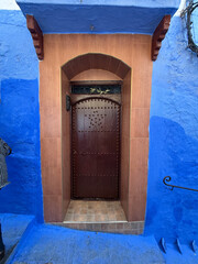Chefchaouen,  the blue city in Morocco -Terracotta doorway in a blue wall